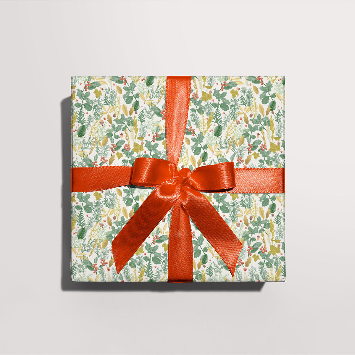 Gift wrapped in Woodland Foliage gift wrap with a red ribbon