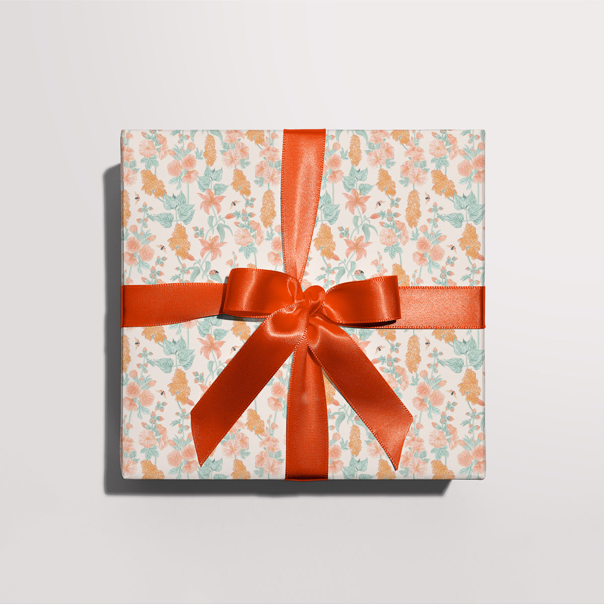Gift wrapped in Poppy & Hummingbird gift wrap with a red ribbon