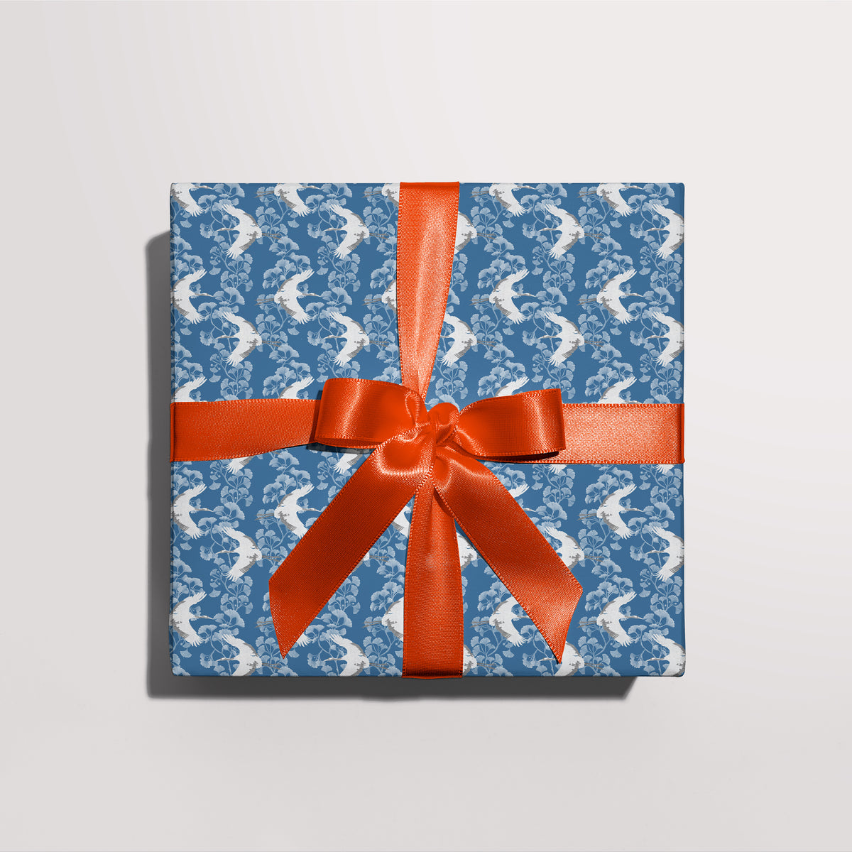 Gift wrapped in Japanese Cranes gift wrap with a red ribbon